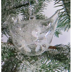 Glass bird shaped tree decoration with mistletoe.
