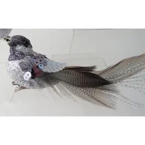 Silver/grey beaded clip on bird with long tail .
